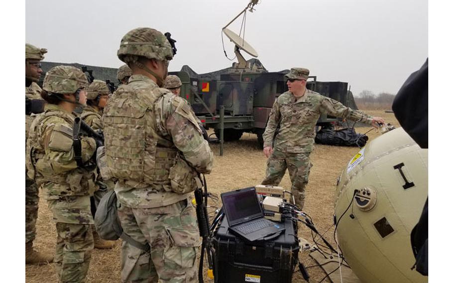 CAMP HUMPHREYS, South Korea - Capt. Zachary Schofield, assistant product manager with Wideband Enterprise Satellite Systems, demonstrates how to use the new Combat Service Support Very Small Aperture Terminal (CSS VSAT) Inflatable Satellite Antenna (ISA) to Soldiers from the 2nd Battalion, 2nd Combat Aviation Brigade maintenance and support company. The CSS VSAT ISA is currently undergoing new equipment training and fielding process in South Korea. (Photo Credit: Amburr Reese)