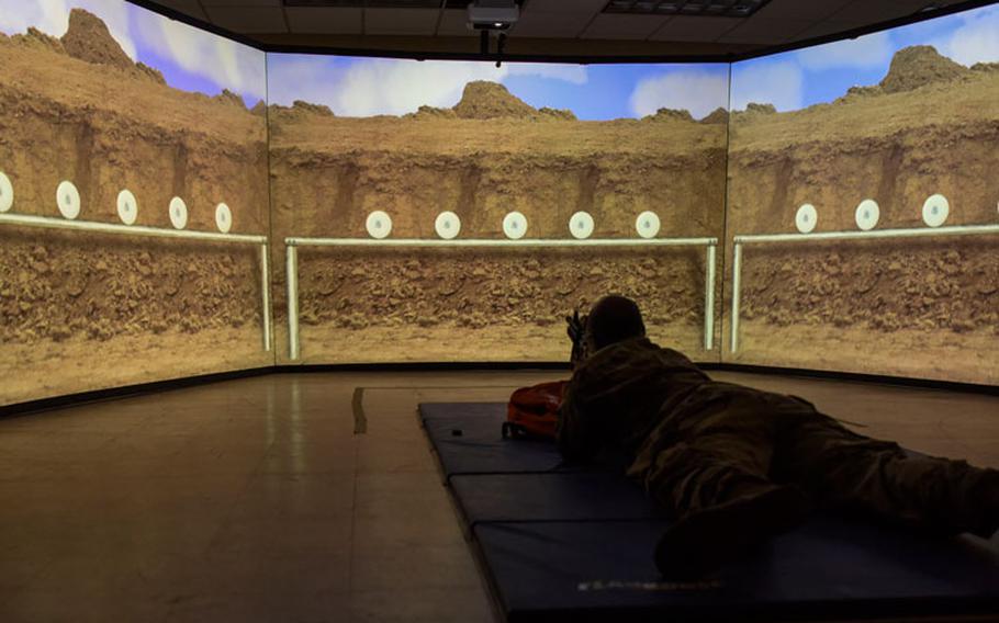 U.S. Army Staff Sgt. Ryan Morris, 411th Contract Support Brigade contracting NCO, demonstrates the multitude of uses of the Multiple Interactive Learning Objectives system at Kunsan Air Base, Republic of Korea, April 20, 2020. MILO is designed to train service members, when a firing range isn’t available, by providing a fully immersive firing range training experience. (U.S. Air Force photo by Senior Airman Jessica Blair)