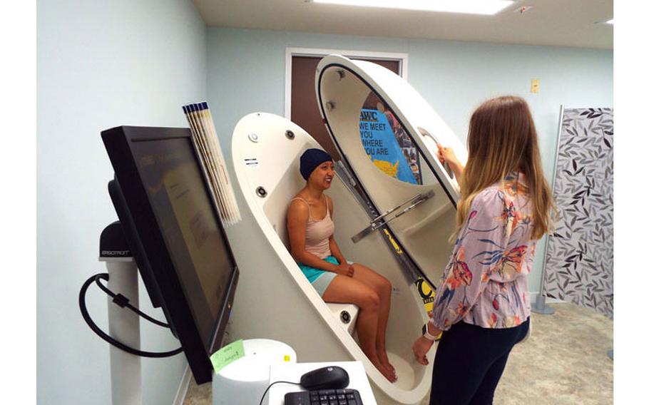 Area IV Health Coordinator, Danielle Sprunger prepares Anna Truong for body composition analysis at the Daegu Army Wellness Center. The test can cost as much as $400 at a commercial facility.  (Photo Credit: Laurel Stone, USAG Daegu Public Affairs Office)