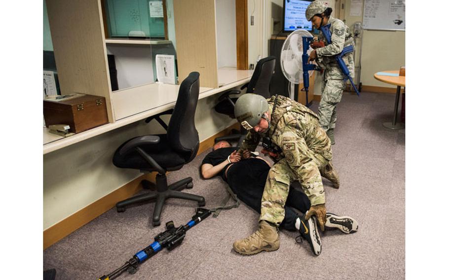 U.S. Air Force Staff Sgt. Brandan Eck (left), and Tech. Sgt. Ashlin Thomas (right), 8th Security Forces Squadron members, search a simulated active shooter during an exercise at Kunsan Air Base, Republic of Korea, July 23, 2019. 8th SFS routinely trains to respond to a variety of threats. (U.S. Air Force photo by Senior Airman Stefan Alvarez)