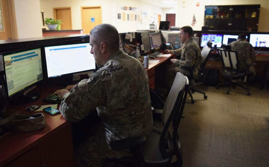 Master Sgt. Daniel Murphy, 51st Operations Support Squadron weather flight chief (front) and Staff Sgt. Kevin Waters, 51st OSS weather craftsman (center), observe live data of sensor information and model forecast products on Osan Air Base, Republic of Korea, September 10, 2020. (U.S. Air force photo by Senior Airman Denise Jenson)