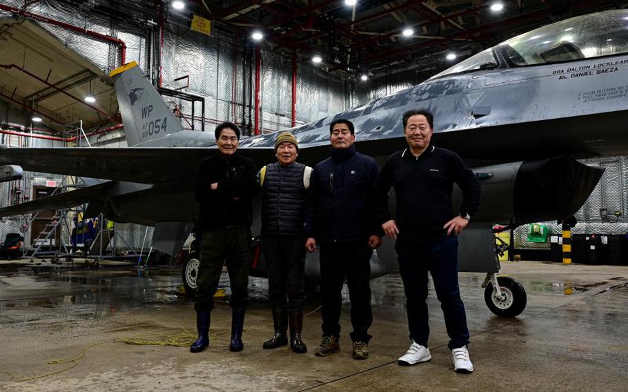 Members of the 8th Maintenance Squadron corrosion control section, pose for a photo in front of an F-16 Fighting Falcon at Kunsan Air Base, Republic of Korea, Feb. 17, 2023. The corrosion control section is composed entirely of Korean National DoD civilians. (U.S. Air Force photo by Senior Airman Shannon Braaten)