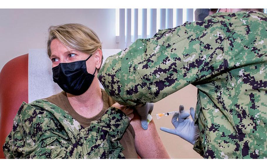 Navy Rear Adm. Anne Swap, National Capital Region director, receives her annual influenza vaccine at the Fort Belvoir Community Hospital. She accompanied Army Lt. Gen. Ronald Place, director of the Defense Health Agency, to the facility as he, too, received his annual flu shot.