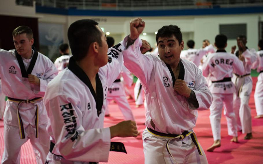 Members from the United States Forces-Korea, practice combatives with Republic of Korea Army soldiers during a Korean Ministry of Defense tour at Muju, Republic of Korea, April 9, 2019. The MND Taekwondo camp gave U.S. service members a chance to practice Taekwondo and learn about its history and importance to Korean culture. (U.S. Air Force photo by Senior Airman Stefan Alvarez)