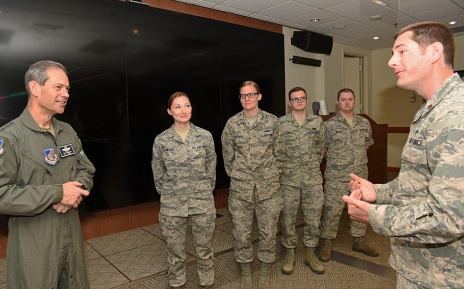 U.S. Air Force Lt. Gen. Kenneth S. Wilsbach, 7th Air Force commander, speaks with Maj. Dustin Burleson, 8th Communications Squadron commander, about the communication security team at Kunsan Air Base, Republic of Korea, July 19, 2019. Wilsbach visited Kunsan to recognize several Airman and hold a town hall meeting for officers. (U.S. Air Force photo by Staff Sgt. Joshua Edwards)