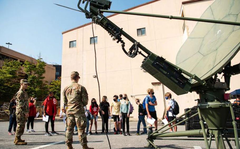 51st Communications Squadron Airmen showcase a satellite display during an open house event at Osan Air Base, Republic of Korea, Oct. 1, 2021. The 51st CS opened their doors for the public to showcase their daily operations to anyone interested in attending and learning more about their mission. The open house included locations previously closed to the public. To make this possible, CS members worked to ensure any classified information was sanitized. (U.S. Air Force photo by Senior Airman Allison Payne)