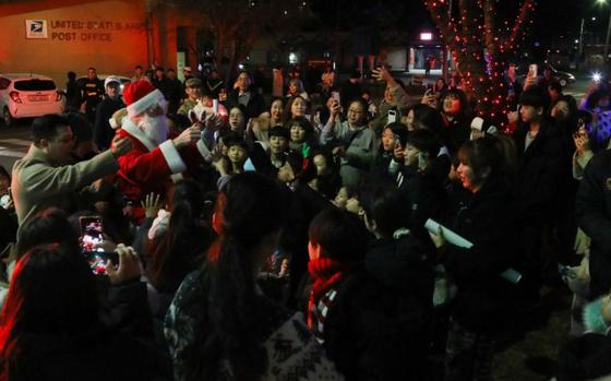 U.S. and Korean Augmentation To U.S. Army (KATUSA) soldiers, families, and guests gather together to celebrate the Annual Holiday Tree Lighting Ceremony.