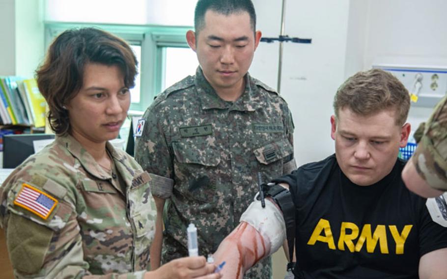 United States Army and Republic of Korea Army medics began their day-long training by treating simulated trauma patients with various wounds at the ROK Ground Operations Command medical treatment facility on Camp Yongin, South Korea, July 28, 2023. Soldiers from the 2501st Digital Liaison Detachment served as casualties complete with mock wounds while the medics went through their procedures to stabilize and prepare the patients for a helicopter medevac. (U.S. Army photo by Pfc. Lee, Sang Eun)