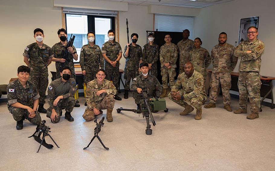 U.S. Air Force and Republic of Korea Air Force Airmen gather after an immersion training at Kunsan Air Base, Republic of Korea, July 21, 2022. The goal of the event was to share knowledge with ROKAF about how the 8th Security Forces Squadron conducts training and to further strengthen the relationship between ROK and U.S. forces. (U.S. Air Force photo by Senior Airman Akeem K. Campbell)