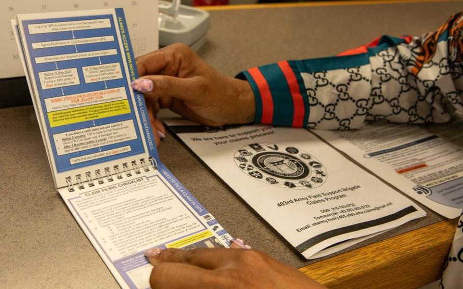 Former claims advisor, current quality assurance/quality control inspector at the 403rd Army Field Support Brigade Logistics Readiness Center-Daegu, and military spouse, Chalon Conley-Mosley, shows one of the informational booklets she made to educate and inform service members about how to submit a claim.