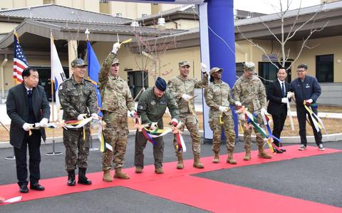 Photo Of Representatives including Col. Peter Kasarskis (fourth from left), commander, 8th Fighter Wing; Col. Jeremiah Willis (third from left), commander, U.S. Army Corps of Engineers – Far East District; Col. Joshua Hawkins (center), commander, 8th Mission Support Group; and others cut the ribbon the new 39,000 square foot dining facility.