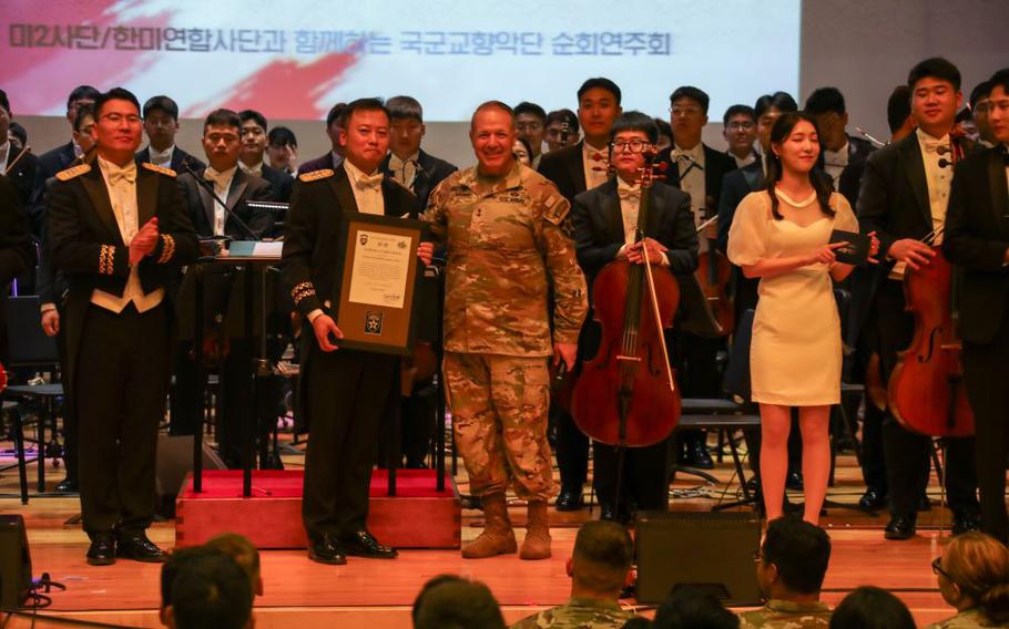 Major General Charles T. Lombardo, Commanding General presents a plaque of appreciation to Conductor Lieutenant Colonel Shim, Un Ho.