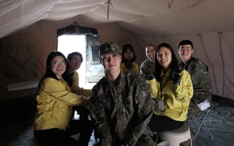 U.S. Army Maj. Nicholas A. Magno (second from right in back) from the 1st Area Medical Laboratory poses with members from Republic of Korea Chemical, Biological, Radiological, Nuclear (CBRN) Defense Command at their headquarters outside of the South Korean capital of Seoul. A native of West Chester, Pennsylvania, Magno said he felt drawn to serve in the U.S. Army because of his family legacy of defending freedom on the Korean Peninsula. (Photo Credit: Courtesy photo)