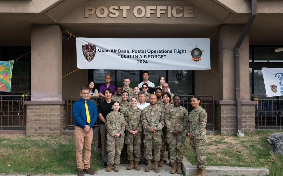 Personnel assigned to the 51st Force Support Squadron Post Office pose for a photo at Osan Air Base, Republic of Korea.