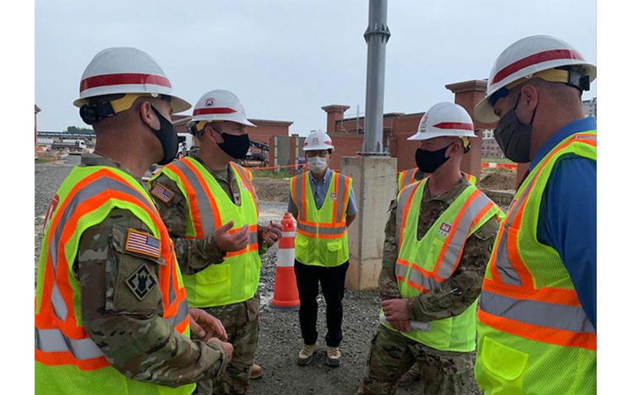 Brig. Gen. Kirk Gibbs, U.S. Army Corps of Engineers Pacific Ocean Division commander (top left), and Command Sgt. Maj. Douglas Galick, POD command sergeant major (top right), visit FED construction site, FH100 Army Family Housing Towers, to view ongoing construction and to speak with the project delivery team at USAG Humphreys, Aug. 25. rmy Family Housing Towers at USAG Humphreys, Aug. 25.