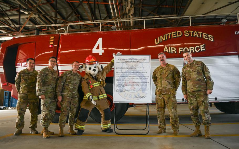 8th Fighter Wing leadership and Kunsan Air Base firefighters gather for a photo after the signing of the installations 2023 Fire Prevention Week proclamation at Kunsan AB, Republic of Korea, Oct. 6, 2023. The Kunsan AB fire department celebrated their 2022 Air Force and Department of Defense fire department of the year awards alongside the start of Fire Prevention week. (U.S. Air Force photo by Senior Airman Karla Parra)