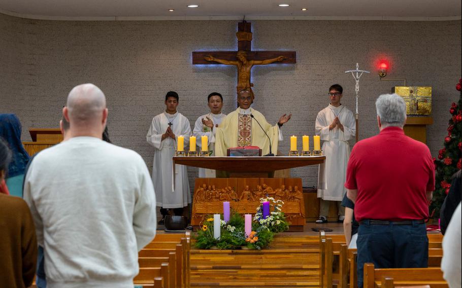 U.S. Air Force Capt. Nelson Ogwuegbu, 51st Fighter Wing chaplain, leads prayer during a joint Catholic mass at Osan Air Base, Republic of Korea, Dec. 8, 2023. The USAF chaplain corps supports the Constitutional right to freely exercise religion for all Airmen and their families. (U.S. Air Force photo by Senior Airman Kaitlin Castillo)