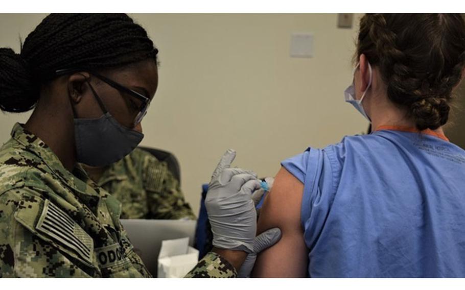 Navy Hospital Corpsman 3rd Class Ilandra O’Doherty of Naval Hospital Bremerton (NHB) administered the influenza vaccination during the start of the command's annual shot exercise (SHOTEX). The seasonal influenza vaccine immunization program at NHB is designed to protect Sailors and Marines, mission-essential healthcare personnel, and eligible beneficiaries. (Photo by Douglas H Stutz, NHB/NMRTC Bremerton.)