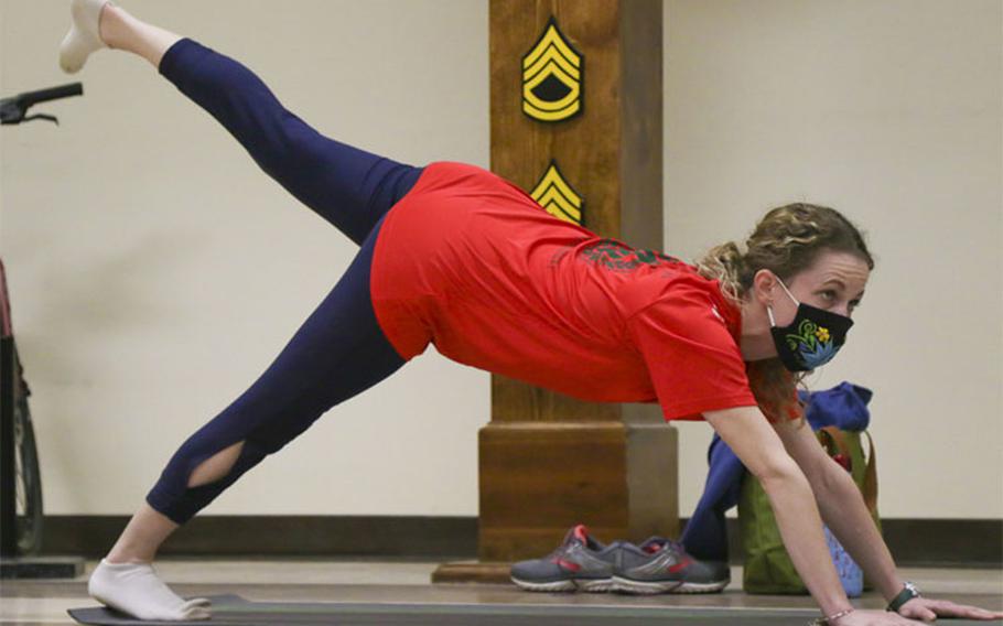 Kelly Brock, the Soldier Family Readiness Group battalion advisor for Headquarters and Headquarters Battalion, 1st Infantry Division, does yoga during an SFRG ‘Yoga for Spouses’ class at the HHBN headquarters building on Fort Riley, Kansas, Jan. 12, 2021. As a part of the Fort Riley SFRG’s Wellness Series, the event was hosted to promote health and wellness within military spouses. (U.S. Army photo by Spc. Alvin Conley)