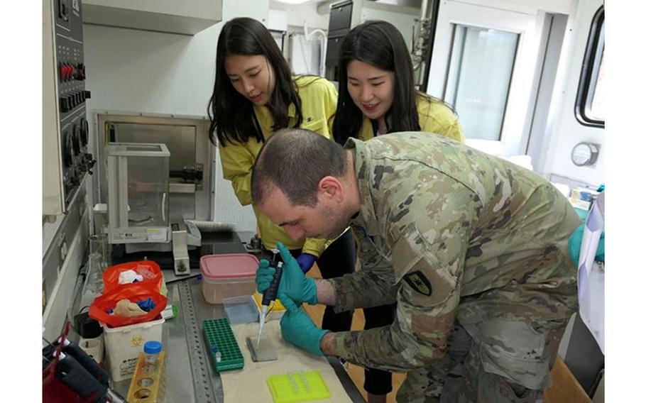 Maj. Nicholas A. Magno (right) from the U.S. Army's 1st Area Medical Laboratory performs hands-on training in the Republic of Korea Chemical, Biological, Radiological, Nuclear (CBRN) Defense Command field analytical biology laboratory. Soldiers from the 1st Area Medical Laboratory trained with South Korean troops from the Republic of Korea CBRN Defense Command at their headquarters outside of the South Korean capital of Seoul. Courtesy photo.