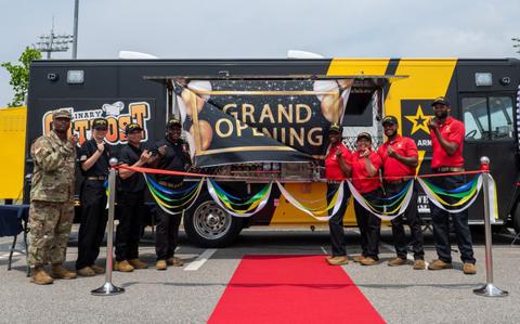 Photo Of Members of the Culinary Outpost food truck gather for a photo before the start of the grand opening ceremony at Camp Humphreys.