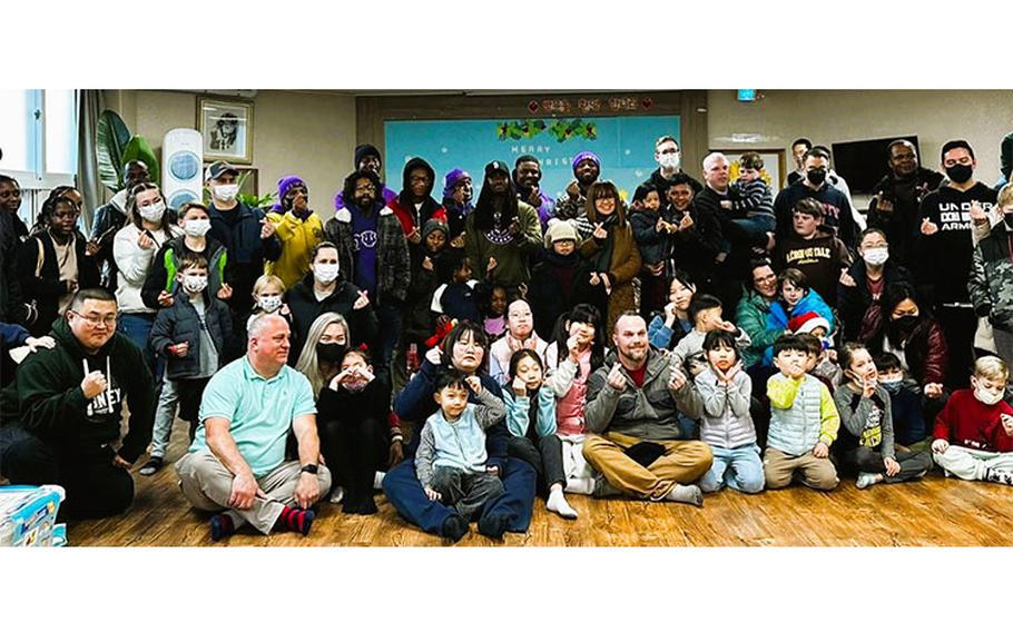 Brothers of Lambda Xi Chapter of the Omega Psi Phi Fraternity, Inc. with volunteers, children, and staff members at the Ae Hyang Children Welfare Center. Photos by Brother Michael Robinson