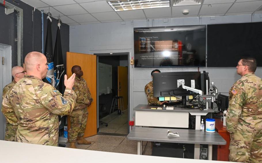U.S. Space Force Chief of Space Operations Gen. Chance Saltzman, right, listens to a briefing from U.S. Space Force Lt. Col. Joshua McCullion, U.S. Space Forces – Korea commander, left, during a visit to Osan Air Base.