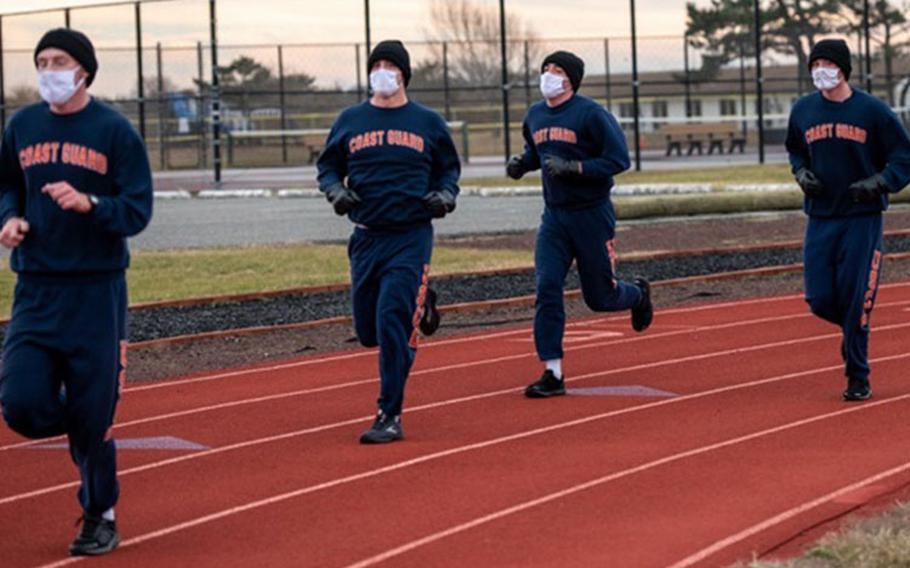 U.S. Coast Guard recruits from company Romeo-199 participate in a Jan. 8 run program on the track at U.S. Coast Guard Training Center in Cape May, New Jersey, as part of their modified training schedule due to COVID-19 restrictions. (Photo by Navy Seaman Josalyn Brown.)