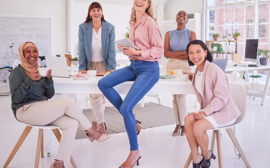 Group of women sitting around a table in business attire