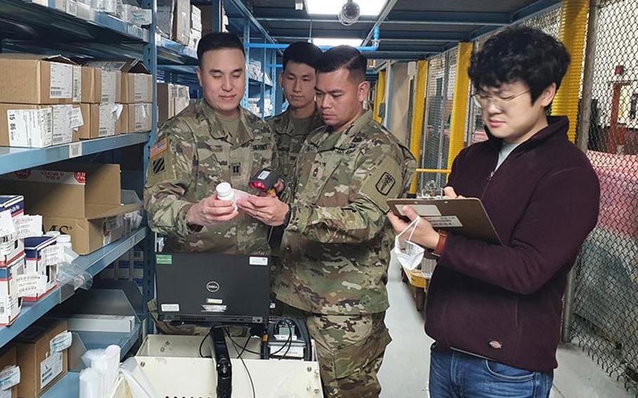 Members of the U.S. Army Medical Materiel Center-Korea's Distribution Center team verify Class VIII medical materiel stock in the warehouse as part of the center's "Brand to Generic" prescription medication initiative. Pictured, from left, are Capt. Benjamin Lee, Pfc. Jin Su Oh, Master Sgt. Rizmel Paguio and Kim Sung-hwan. (U.S. Army photo by Paek Hye-chin)