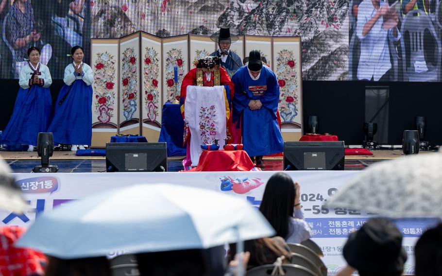 U.S. Air Force Senior Airman Gabriel Mercado, 51st Force Support Squadron member, participates with his wife in a traditional Korean wedding ceremony outside Osan Air Base, Republic of Korea, Sept. 28, 2024.