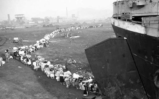 Photo Of Refugees boarding a ship at Hungnam Harbor, North Korea, 21 December 1950.