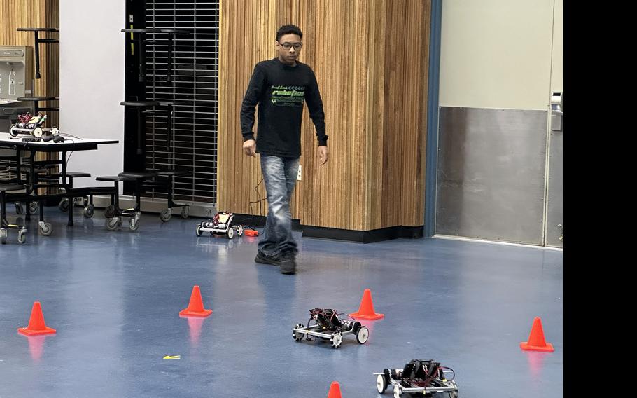 Camden Dotson monitors the robot car activity on Science Day in the Humphreys High School gym at Camp Humphreys.