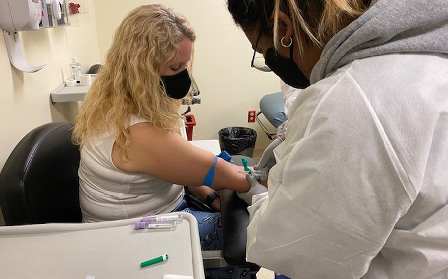 A student from Osan Middle High School helps draw blood from a patient during her internship with the 51st Medical Group at Osan Air Base, Republic of Korea. Over 50 juniors and seniors have participated in the Career Practicum Program throughout the year of 2022. (Courtesy photo by Bridget Heffele)