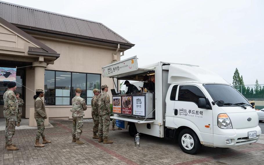 8th Fighter Wing Airmen wait to order food at a new food truck at Kunsan Air Base, Republic of Korea, May 22, 2023. To assure the quality of food, the 8th Medical Group’s public health flight conducted a health inspection on the food storage and preparation procedures. (U.S. Air Force photo by Staff Sgt. Sadie Colbert)