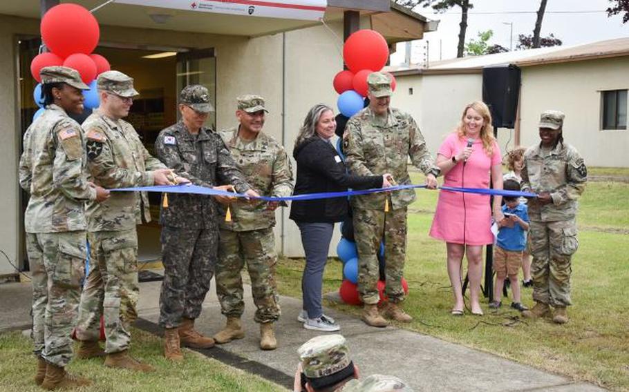 Maj. Gen. William “Hank” Taylor, Lindsey Geraci, and Jennifer Brock cut the ribbon on the new Warrior Food Pantry on Camp Humphreys.