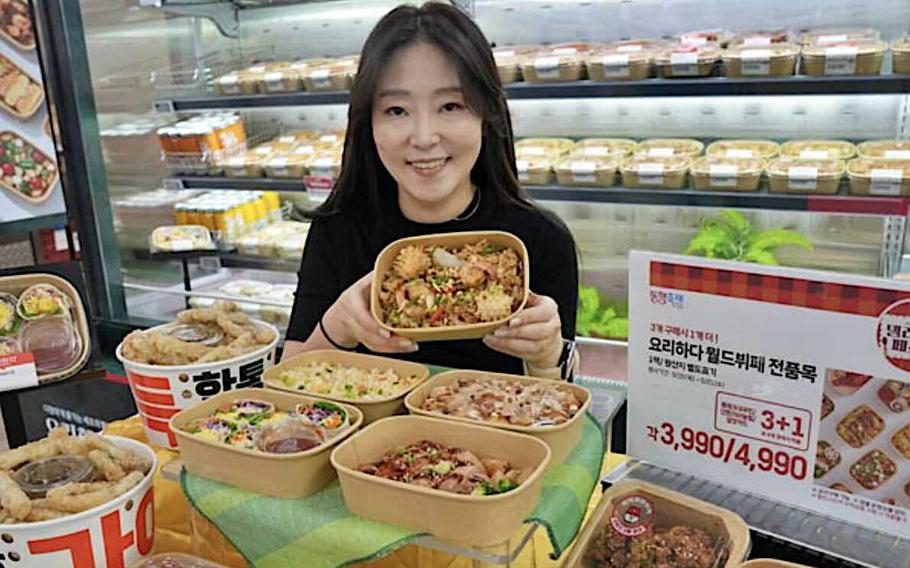 a lady holding a ready-meal at Lotte Mart