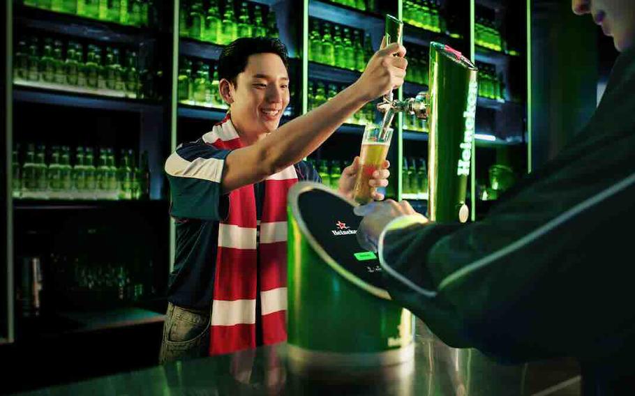 pouring Heineken beer