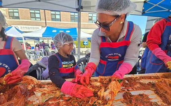 mother and son making kimchi