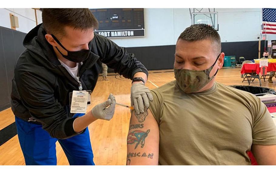 Ian Sheer, Keller Army Community Hospital at West Point nursing student, administers a COVID-19 booster to Master Sgt. Jose Rivera, 1179th Transportation Surface Brigade, during a COVID-19 booster shot clinic at the Fitness Center, U.S. Army Garrison Fort Hamilton, New York, Feb. 24, 2022. The DOD remains committed to protecting our service members, civilian employees, and families around the globe; safeguarding our national security capabilities; and supporting the whole-of nation response to COVID-19.