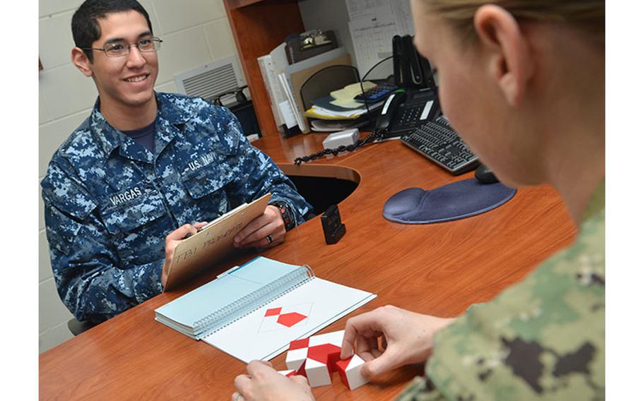 U.S. Navy Hospitalman David Vargas (left), a behavioral health technician at Naval Hospital Jacksonville, conducts a block design test on a patient to assess functioning of the parietal and frontal lobes.