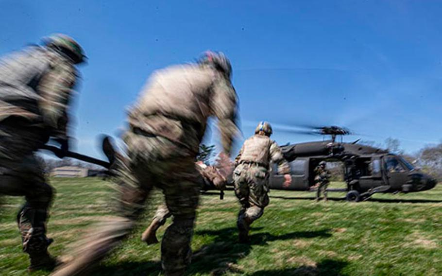 U.S. Army Soldiers load a simulated patient on to a New Jersey National Guard UH-60L Black Hawk helicopter during a combat lifesaver course run by the Medical Simulation Training Center on Joint Base McGuire-Dix-Lakehurst, New Jersey, April 14, 2022. (U.S. Air National Guard photo by Master Sgt. Matt Hecht)