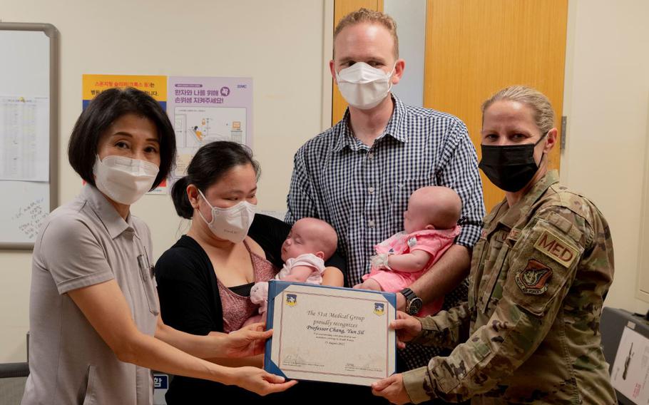 Col. Jennifer Vecchione, 51st Medical Group Commander, presents Professor Yun Sil Chang, lead Neonatal Intensive Care Unit (NICU) physician, with a certificate of appreciation at the Samsung Seoul Hospital, Republic of Korea, Aug. 25, 2022. The 51st MDG leadership team visited the hospital to celebrate the discharge of two triplets from the NICU and show their appreciation to the Samsung medical staff. (U.S. Air Force Photo by Senior Airman Trevor Gordnier)