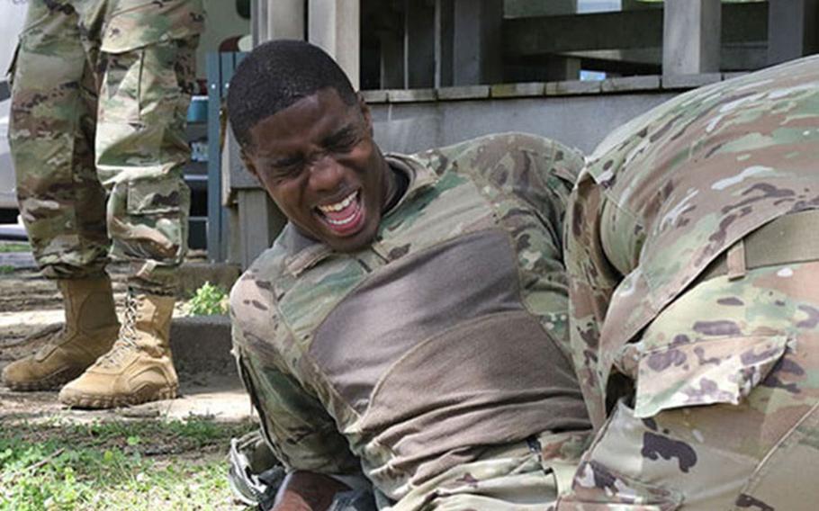 A soldier Washington fights through the pain after completing a 12-mile ruck march April 11, 2019, at the Vicksburg National Military Park in Vicksburg, Mississippi (Photo by U.S. Army National Guard photo by Sgt. DeUndra Brown).