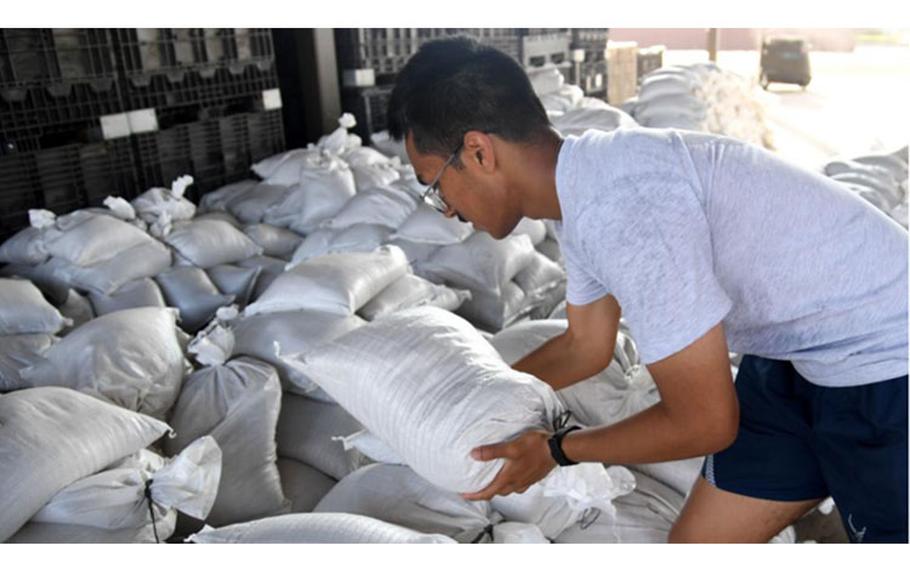 An Airman stacks sand bags in preparation for the 2022 hurricane season at Keesler Air Force Base, Mississippi, June 27, 2022. (U.S. Air Force photo by Kemberly Groue)