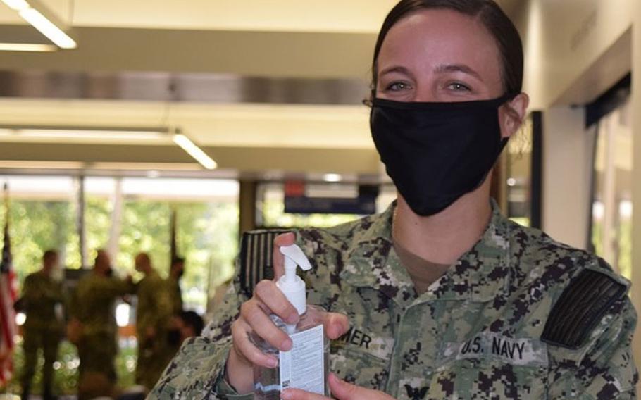 Navy Hospital Corpsman 3rd Class Mae Larimer, assigned to Navy Medicine Readiness Training Unit Bangor helps patients and visitors at the medical clinic to daily mitigate any potential spread of the ongoing pandemic outbreak as well as seasonal influenza virus. (Photo by Douglas Stutz.)