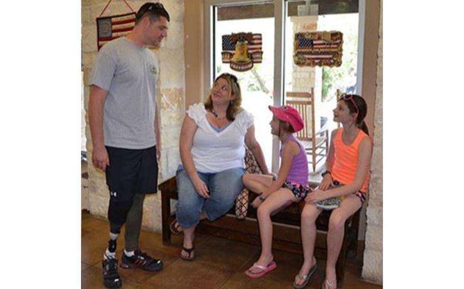 Genette Burges spends time with her husband Dan and children at the Warrior and Family Support Center at Joint Base San Antonio (Photo by: Lori Newman, Brooke Army Medical Center).