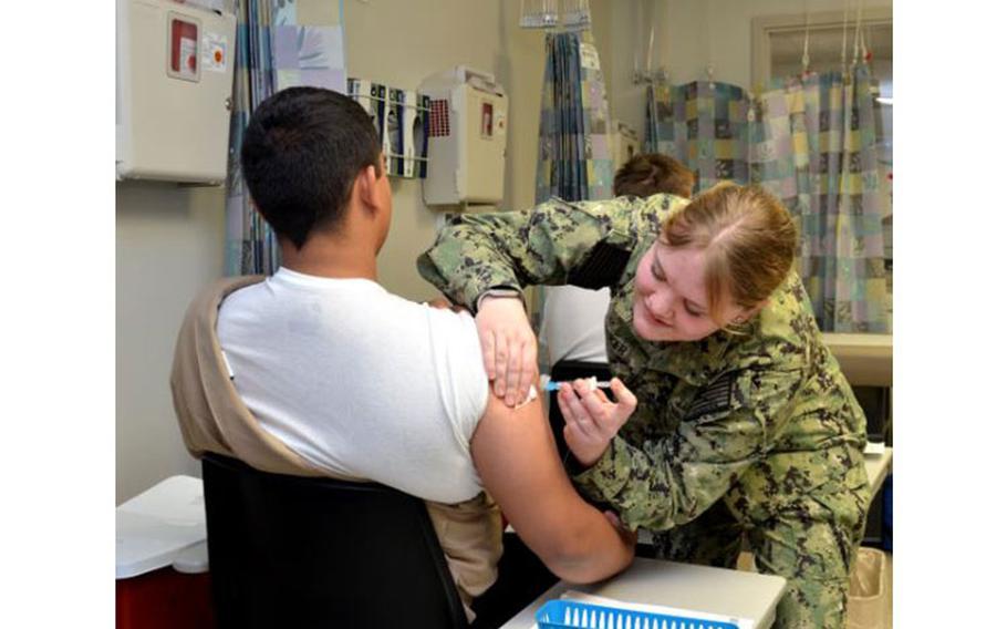 Hospitalman Allesyn Welker administers a vaccine to a patient at Naval Branch Health Clinic King Bay’s Immunizations Clinic. Welker, a native of St. Louis, Missouri, says, “I enjoy getting to know the patients, giving them the information they need, and explaining the process along the way.” (U.S. Navy photo by Deidre Smith, Naval Hospital Jacksonville/Released).