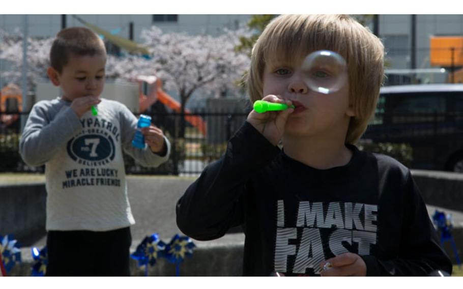 A child at Marine Corps Air Station Iwakuni blows bubbles during a recent Month of the Military Child celebration. (U.S. Marine Corps photo by Cpl. Gabriela Garcia-Herrera)