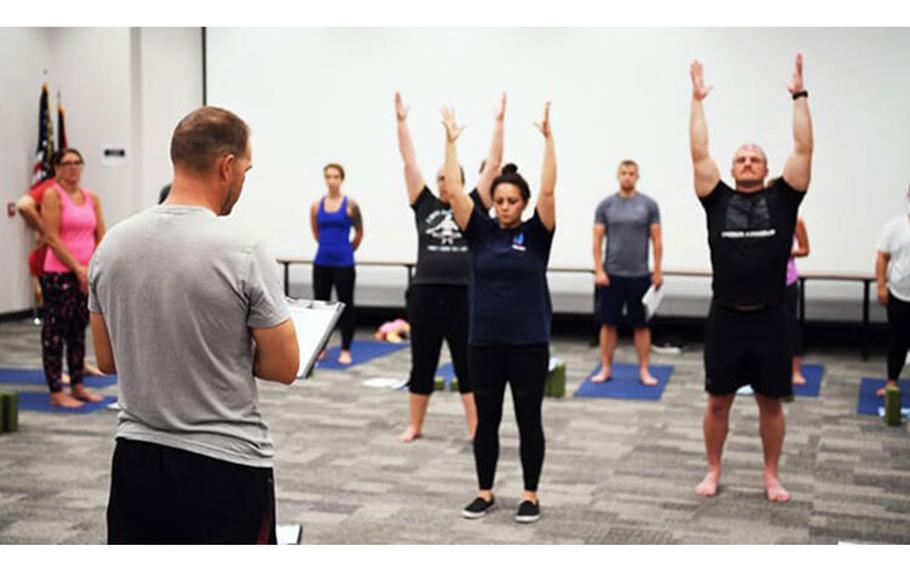 An Airman practices leading a yoga class July 18, 2022, at the 178th Wing in Springfield, Ohio. The training is a part of a pilot program called Yoga Shield, which aims to teach Airmen to reduce stress and to build mental and physical resiliency through yoga.